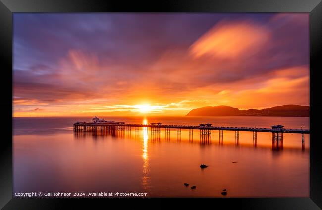 Sunrise over llandudno Pier with the tide in  Framed Print by Gail Johnson