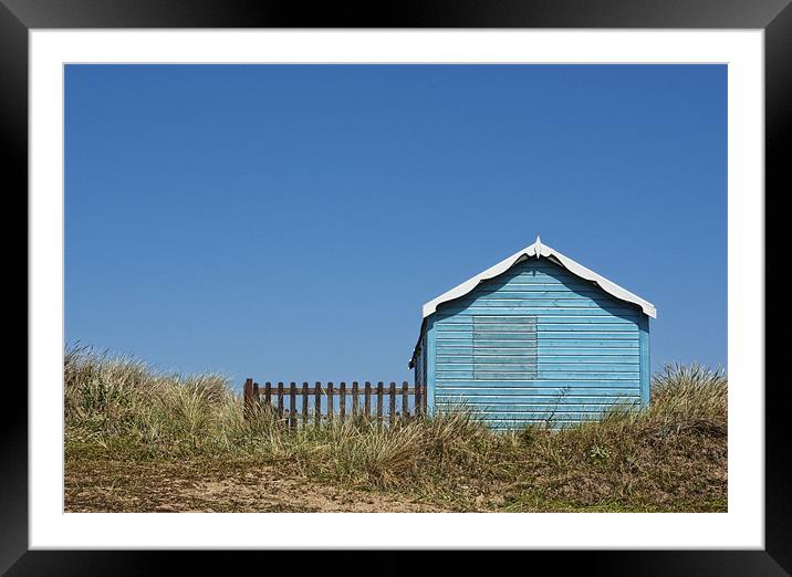 Blue beach hut on a hill Framed Mounted Print by John Edwards