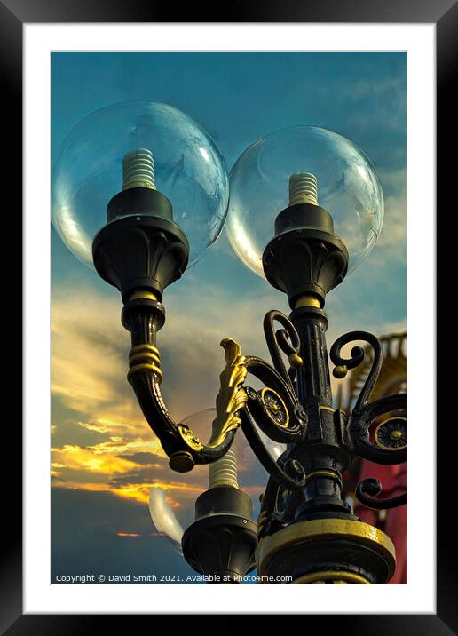 Decorative lights against a darkening sky Framed Mounted Print by David Smith