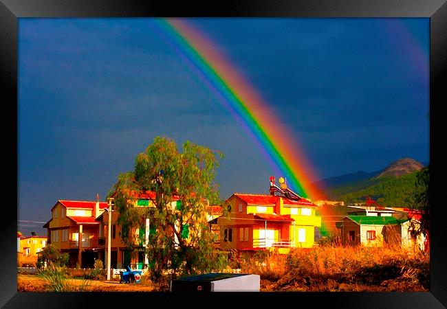 A digital painting of a rainbow over villas in the Framed Print by ken biggs