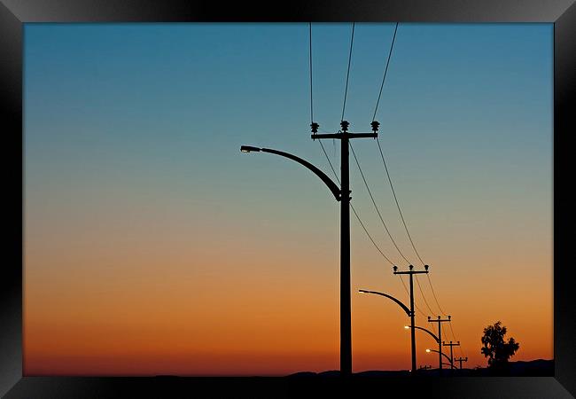 Electric power lines against a dawn sky Framed Print by ken biggs