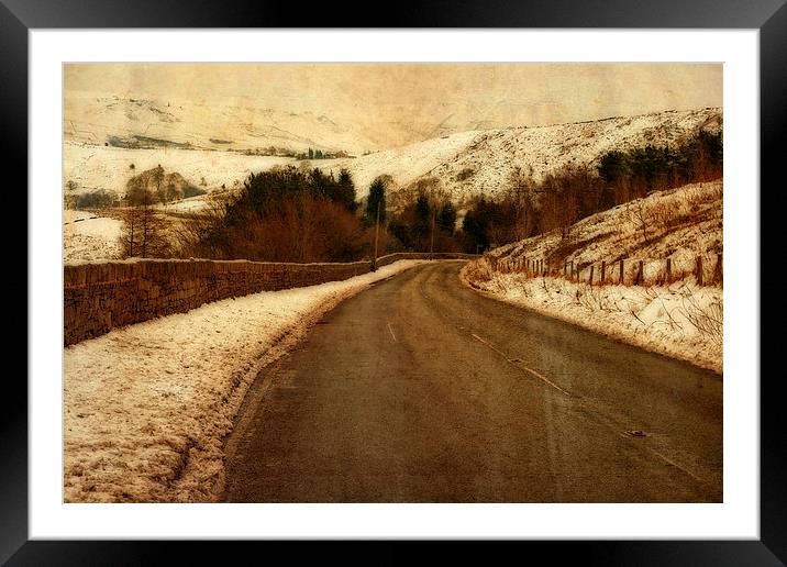 Empty road through snow covered Yorkshire moors Framed Mounted Print by ken biggs