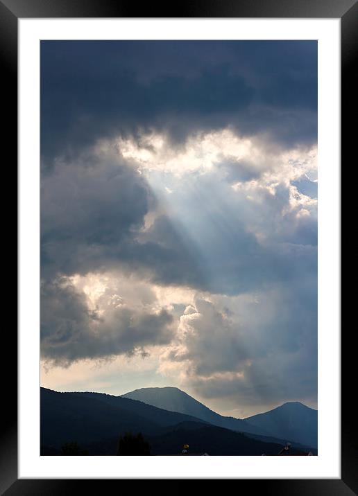 Sun rays through storm clouds Framed Mounted Print by ken biggs