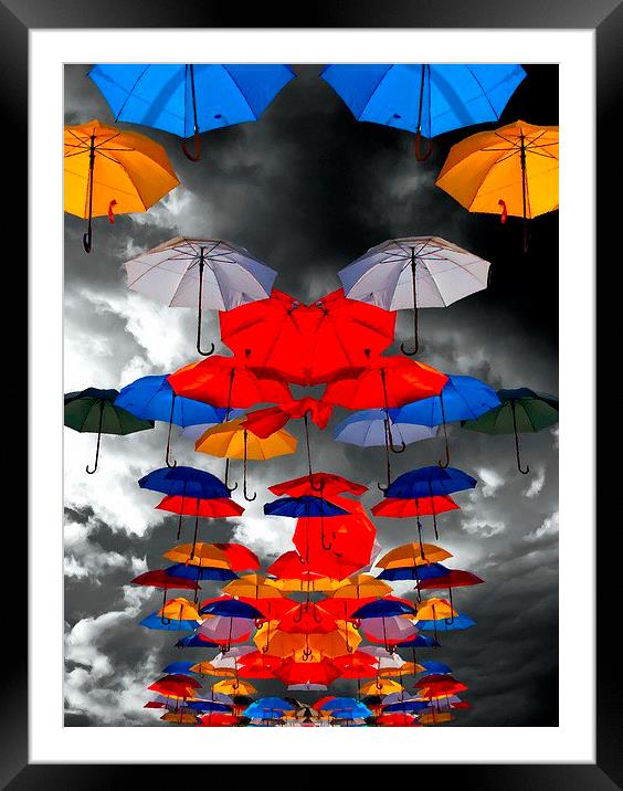 colorful umbrellas against a stormy sky Framed Mounted Print by ken biggs