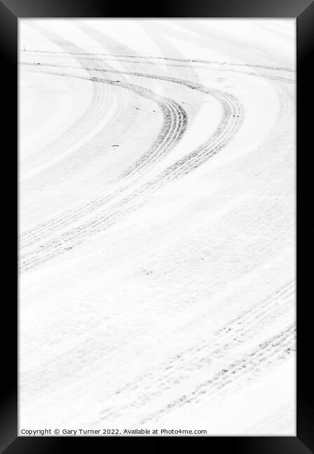 Curving tracks in the snow Framed Print by Gary Turner