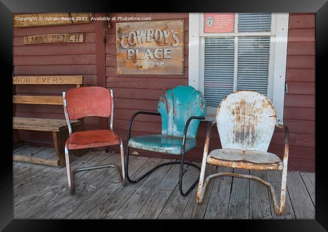 Coloured chairs on a cowboy veranda Framed Print by Adrian Beese