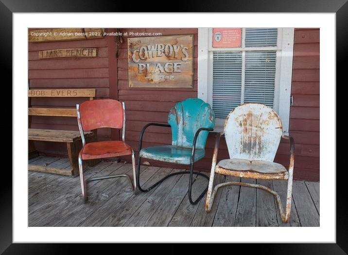 Coloured chairs on a cowboy veranda Framed Mounted Print by Adrian Beese
