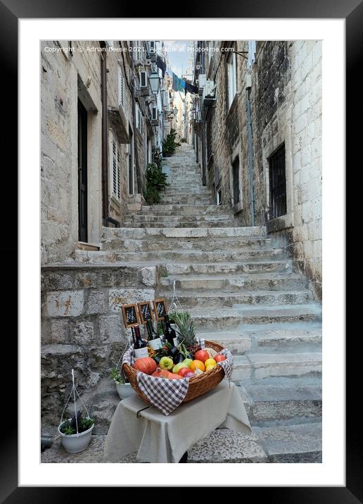 Basket of wine and fruit in Dubrovnik Framed Mounted Print by Adrian Beese