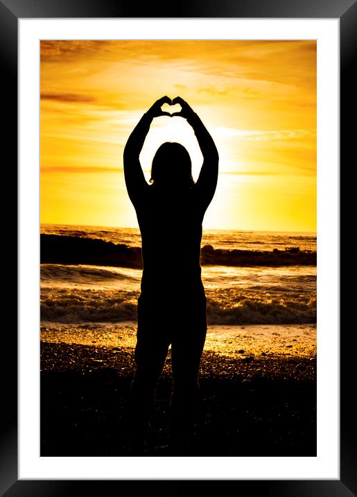 Silhouette of love sunset at Ogmore, UK. Framed Mounted Print by Owen Bromfield