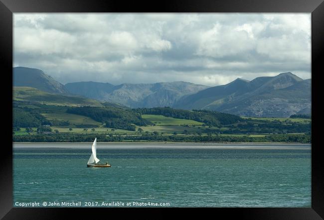 Snowdonia from the Menai Straits on a cloudy day Framed Print by John Mitchell