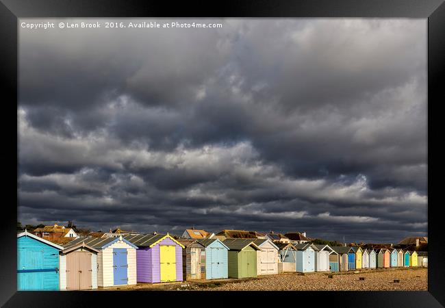 Ferring Beach Huts Under a Brooding Sky Framed Print by Len Brook