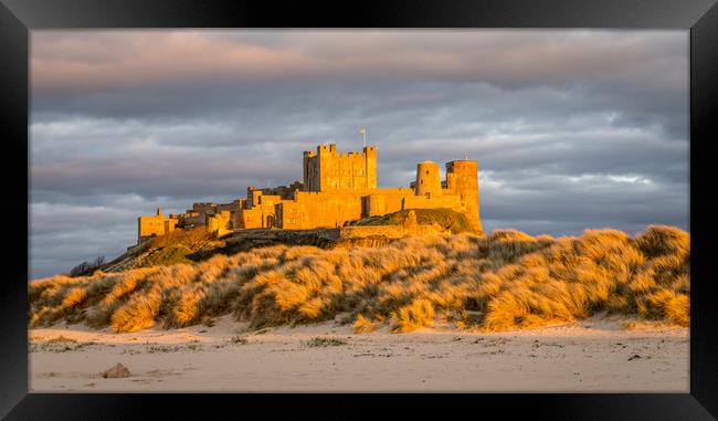 Sun setting on Iconic Bamburgh Castle Framed Print by Naylor's Photography
