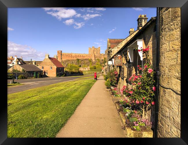 Bamburgh cottages and imposing castle Framed Print by Naylor's Photography