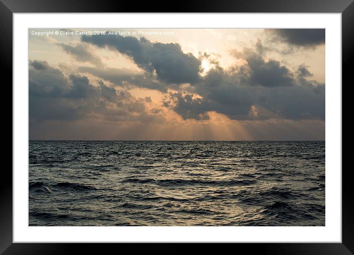 Sun rays over the ocean Framed Mounted Print by Claire Castelli