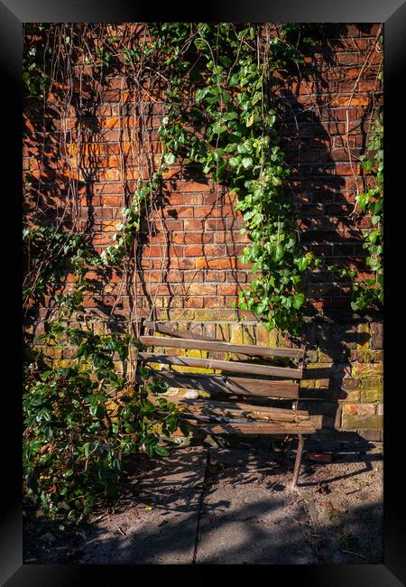 Old Wooden Broken Bench By The Brick Wall Framed Print by Artur Bogacki