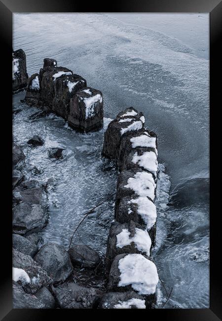 Old Wooden Posts In Frozen River Framed Print by Artur Bogacki