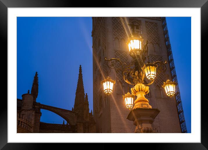 Fuente De La Farola Lamp Against Giralda Tower In Seville Framed Mounted Print by Artur Bogacki
