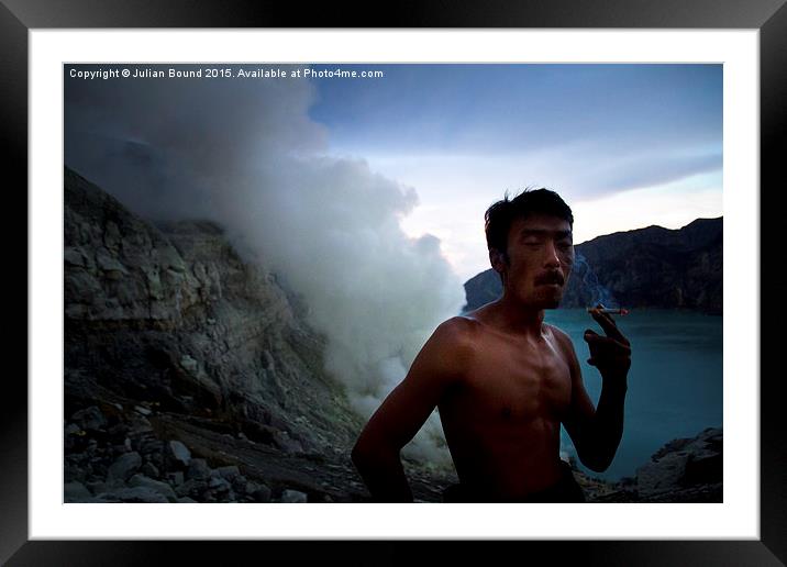 Sulphur miner of Ijen volcano, Java, Indonesia Framed Mounted Print by Julian Bound
