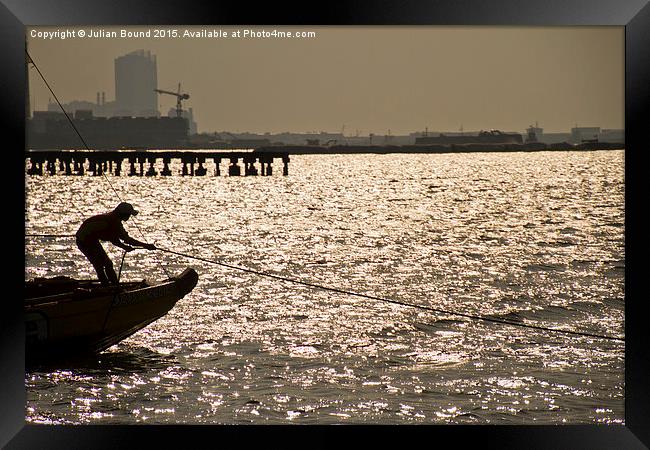 Boat and sailor, the marina of Jakarta, Indonesia Framed Print by Julian Bound