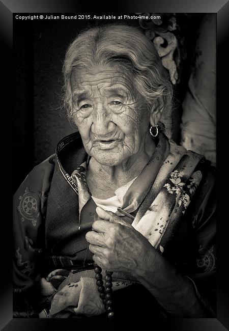 Elderly Tibetan lady, Boudhanath Temple, Kathmandu Framed Print by Julian Bound