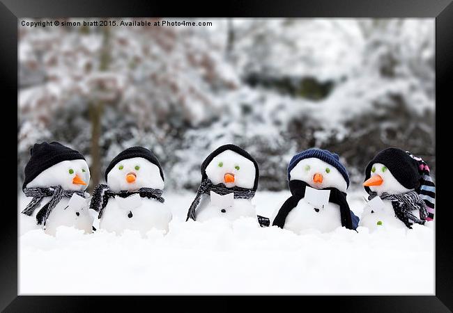 Cute snowman group in snow  Framed Print by Simon Bratt LRPS