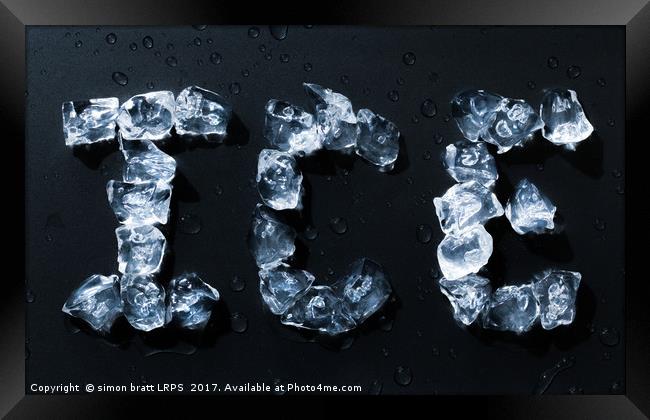 Ice written with ice cubes on dark background Framed Print by Simon Bratt LRPS