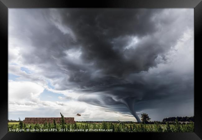 Storm tornado or twister lifting hay bales in stor Framed Print by Simon Bratt LRPS