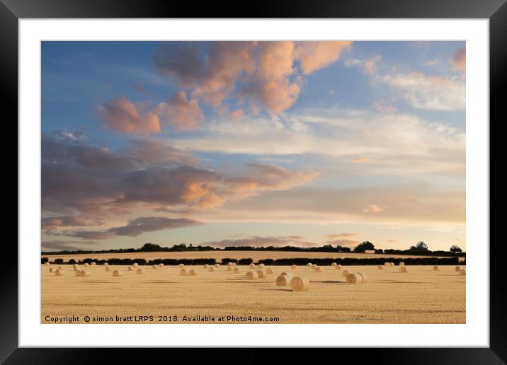 Norfolk hay bales basking in the sunset glow Framed Mounted Print by Simon Bratt LRPS