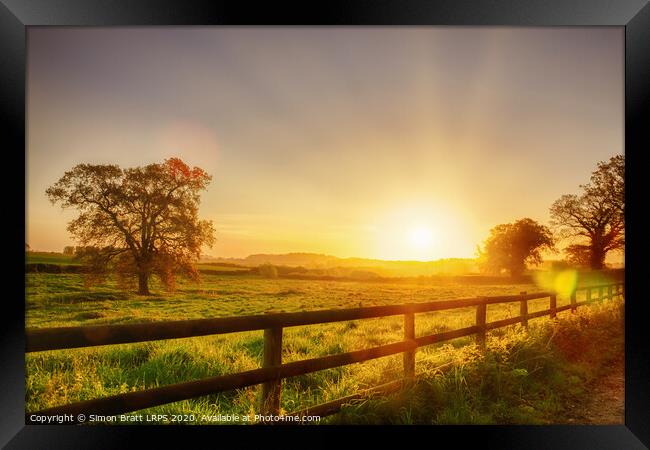 Rural sunrise over fenced field Framed Print by Simon Bratt LRPS