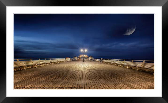 Cromer Pier Norfolk under a moon lit sky Framed Mounted Print by Simon Bratt LRPS