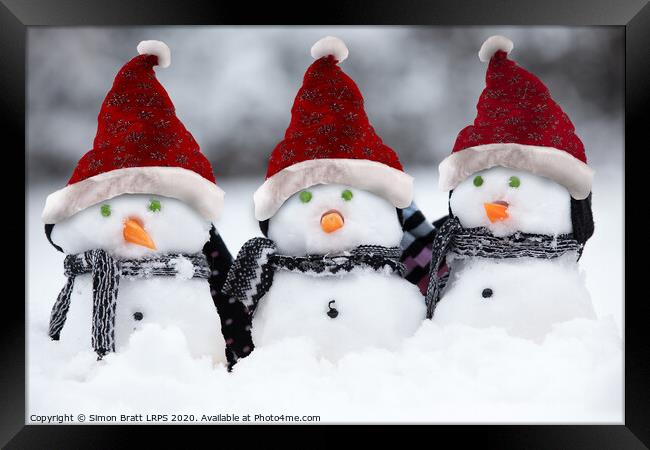 Snowmen with Christmas hats Framed Print by Simon Bratt LRPS