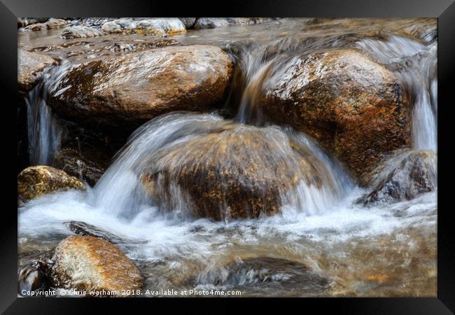 Water splashing over rocks in a mountain stream Framed Print by Chris Warham