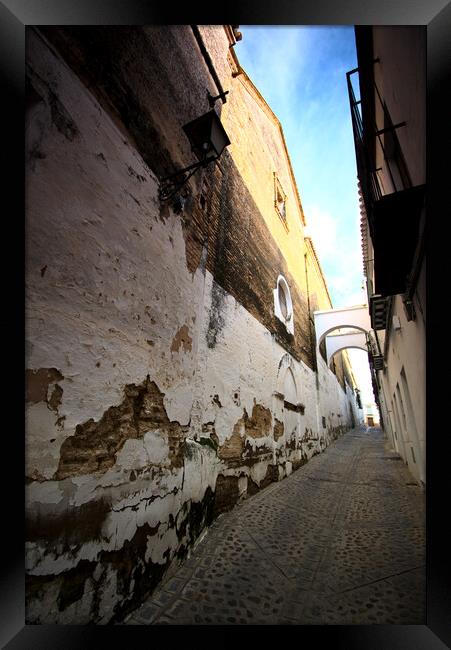 Narrow and lonely street with arch Framed Print by Jose Manuel Espigares Garc