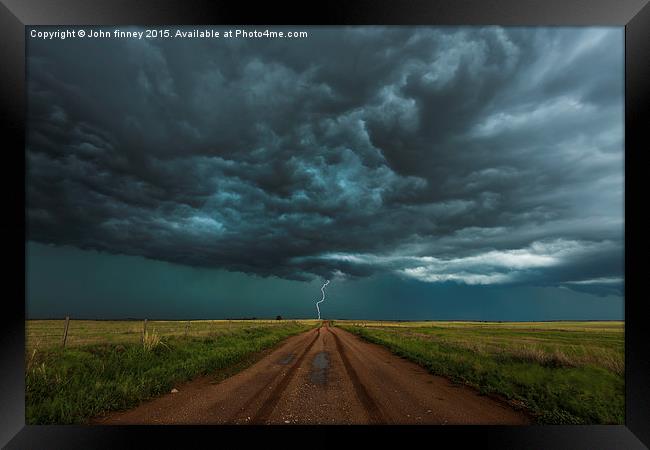  Lightning, End of the road. Tornado alley, USA.  Framed Print by John Finney