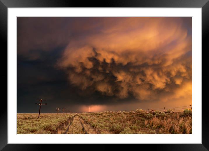 Distant Lightning with sunset storm clouds Framed Mounted Print by John Finney