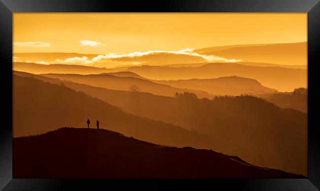 Two people stand on a mountain  Framed Print by John Finney