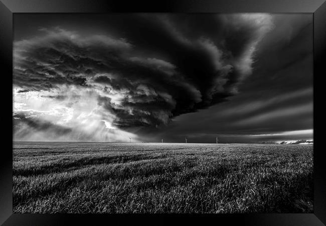 Sunlight through a storm. black and white Framed Print by John Finney