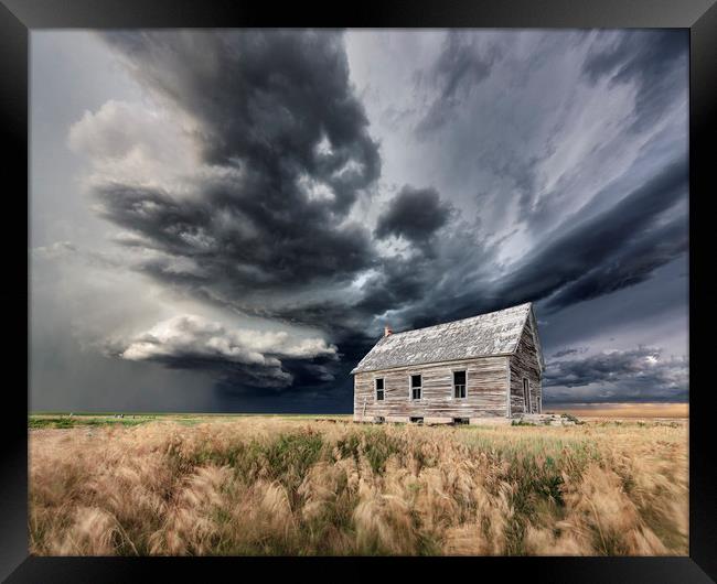 Abandoned Schoolhouse with a Storm, Colorado Framed Print by John Finney