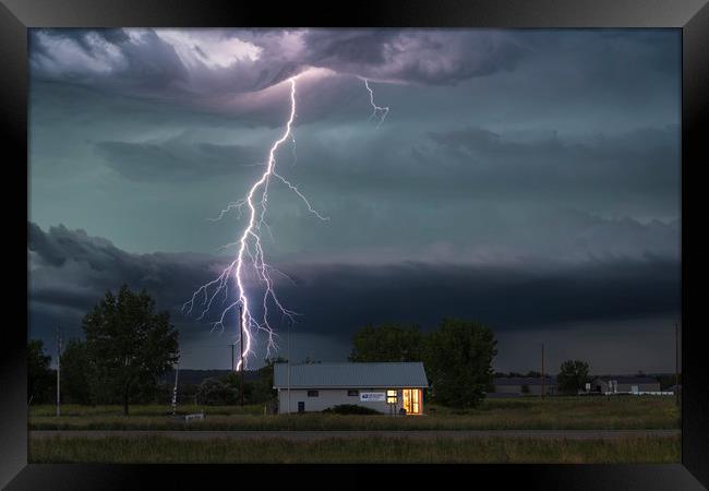 Forked Lightning Over a Montana Post Office, USA.  Framed Print by John Finney