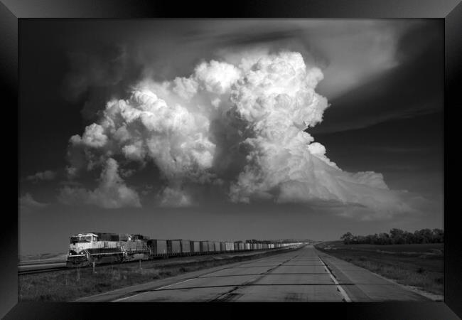 Storm over Freight train, Tornado alley, USA. Framed Print by John Finney