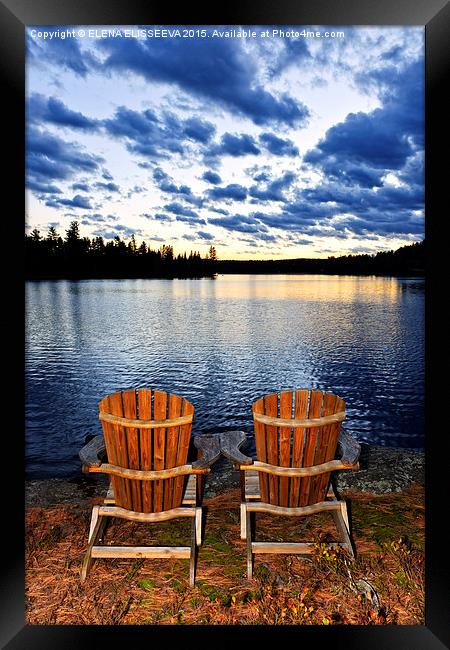 Wooden chairs at sunset on lake shore Framed Print by ELENA ELISSEEVA