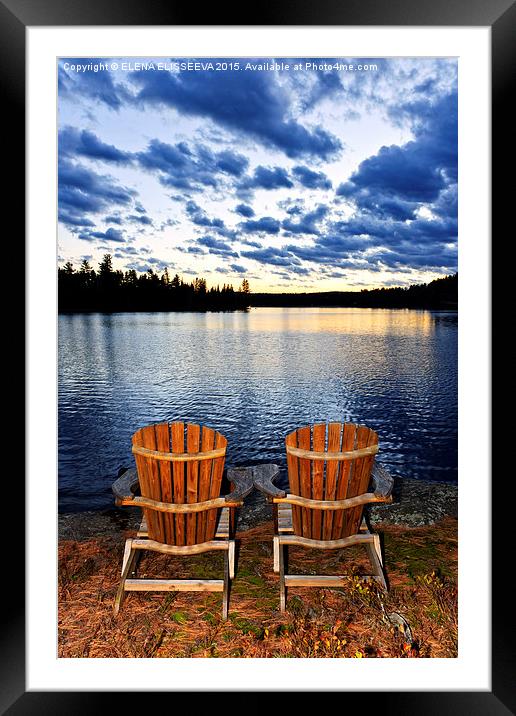 Wooden chairs at sunset on lake shore Framed Mounted Print by ELENA ELISSEEVA