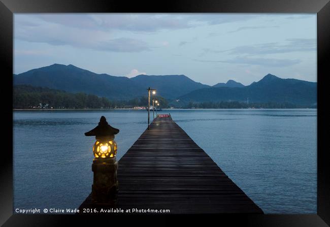 Dusk over jetty in Thailand Framed Print by Claire Wade