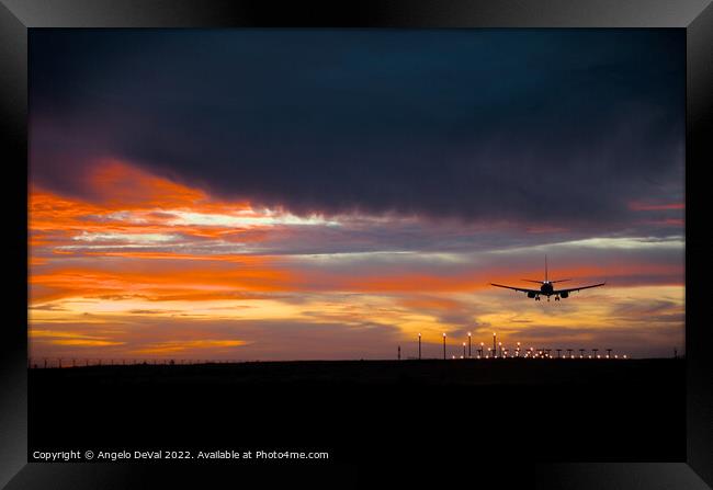 Airplane Landing at Dusk Framed Print by Angelo DeVal