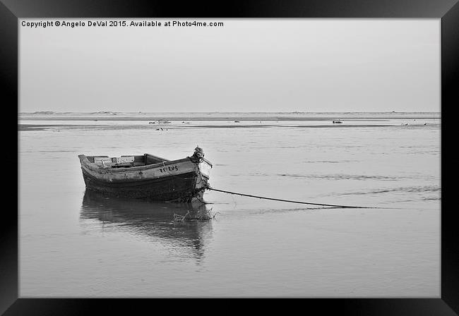 Fishing boat resting on the low tide  Framed Print by Angelo DeVal
