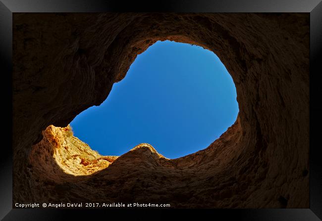 Blue sky thru cliff opening Framed Print by Angelo DeVal