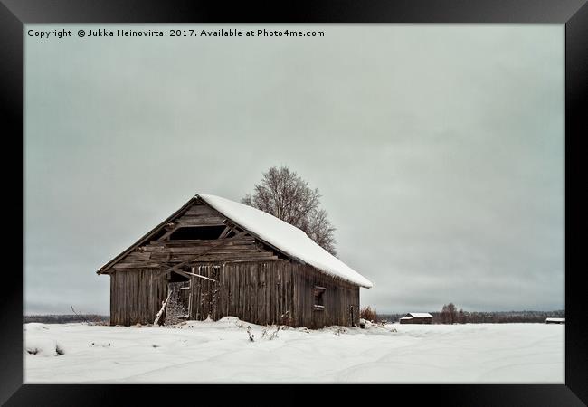 Barns On The Snowy Fields Framed Print by Jukka Heinovirta