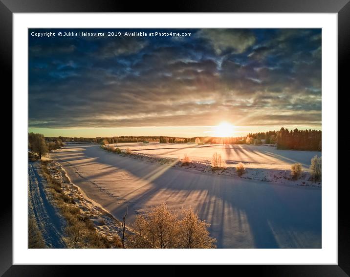 Sun Rising Over The Frozen River Framed Mounted Print by Jukka Heinovirta