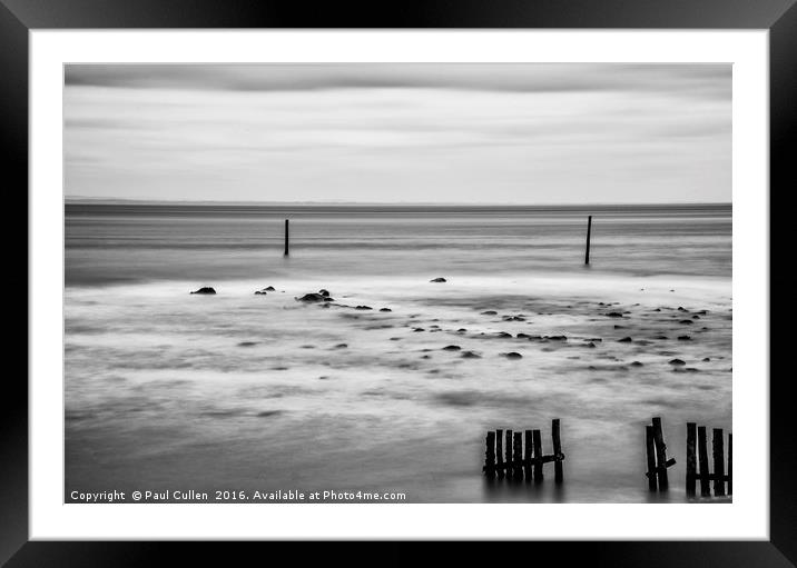 Wooden posts in the sea. Monochrome. Framed Mounted Print by Paul Cullen