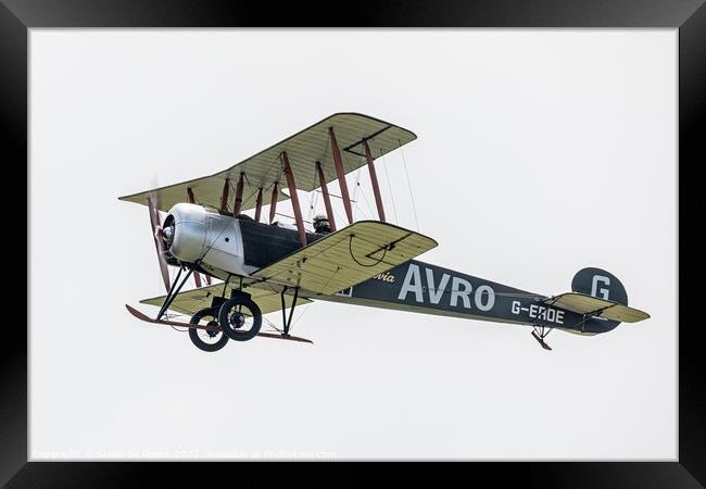 Avro 504K flies past in a cloudy sky Framed Print by Steve de Roeck